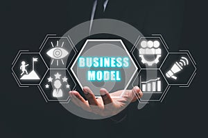 Businessman hand holding business model icon on virtual screen