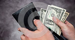 Businessman hand holding cash dollar in wallet