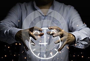 Businessman hand holding clock  on black background. Time is important and everybody get 24 hours. Time management concept