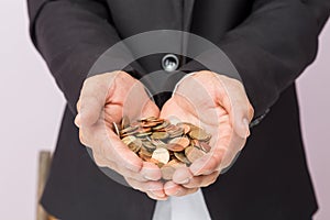 Businessman hand holding the coins, concept of saving  money for finance accounting