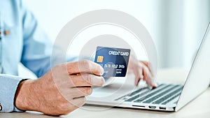 Businessman hand holding credit card to online shopping from home, payment e-commerce, internet banking, spending money for next