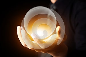 Businessman hand holding a Crystal Ball