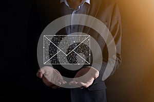 Businessman hand holding e-mail icon, Contact us by newsletter email and protect your personal information from spam mail.