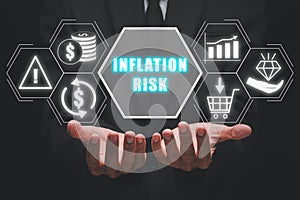 Businessman hand holding inflation risk icon on virtual screen