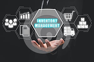 Businessman hand holding inventory management icon on virtual screen