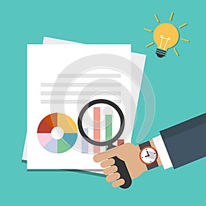 Businessman hand holding magnifying glass over document with graph, reports icon. Data analysis, idea concept with light bulb