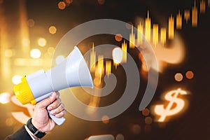 Businessman hand holding megaphone with virtual business finance graph