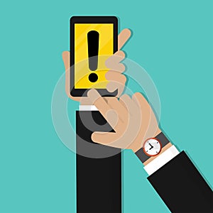 Businessman hand holding mobile phone with Yellow warning mark. Danger warning attention sign
