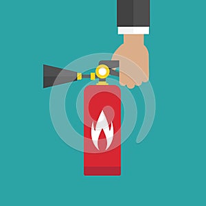 Businessman hand holding red fire extinguisher isolated on blue background