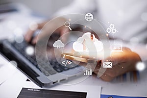 Businessman hand holding smartphone and laptop with cloud computing diagram show on hand. Cloud technology.