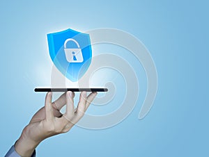 Businessman hand holding smartphone showing shield icon with lock sign Computer password protection concept, internet network