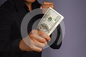 Businessman hand holding of US banknotes and a fist while standing in a studio.