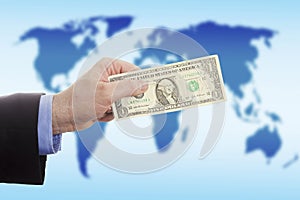Businessman hand over money against world map