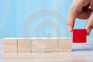 Businessman hand placing or pulling Red wooden block on the building. Business planning, Risk Management, Solution, strategy,