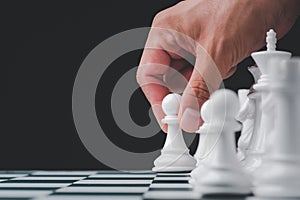 Businessman hand play with chess game. concept of business strategy and tactic.strategy, management or leadership concept