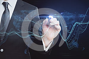 Businessman hand pointing at creative glowing business chart and map hologram on blurry background. Business data and market