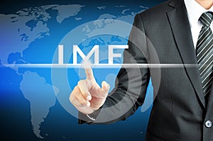 Businessman hand pointing to IMF (International Monetary Fund) sign