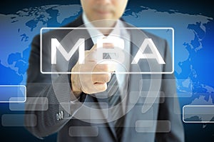Businessman hand pointing to MBA sign on virtual screen photo