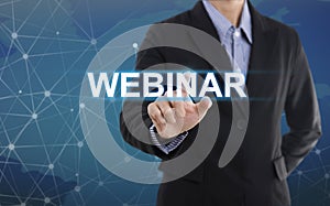 Businessman hand pressing button webinar.