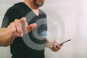 Businessman hand pressing an imaginary button,holding smart phone,digital screen graphic virtual icons,graph,diagram,filter effect