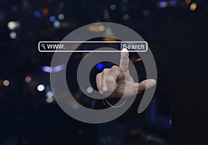 Businessman hand pressing search www button over blur light city