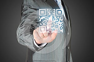 Businessman with hand pressing virtual qr code