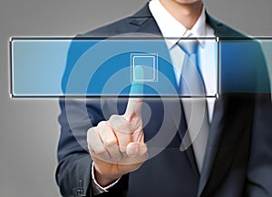 businessman hand pushing button on a touch screen interface with blue background