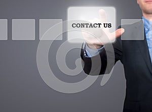 Businessman hand pushing contact us button on a touch screen int