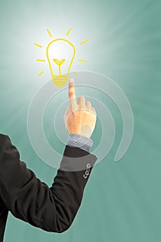 Businessman hand pushing light bulb idea