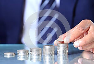 Businessman hand put coins