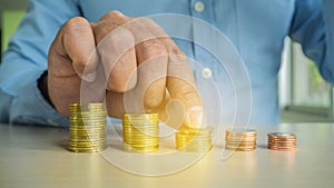 Businessman Hand Put Coins To Stack Of Coins