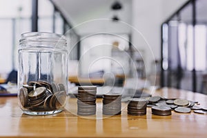 businessman hand putting coin in piggy bank. Saving money concept, business finance and investment