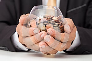 Businessman hand putting the coins on the glass, concept of saving  money for finance accounting