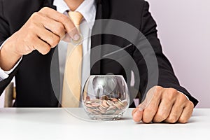 Businessman hand putting the coins on the glass, concept of saving  money for finance accounting