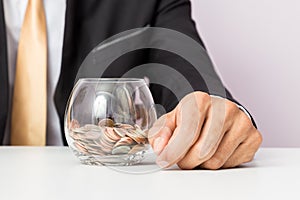 Businessman hand putting the coins on the glass, concept of saving  money for finance accounting