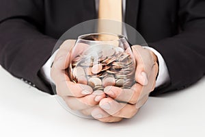 Businessman hand putting the coins on the glass, concept of saving  money for finance accounting