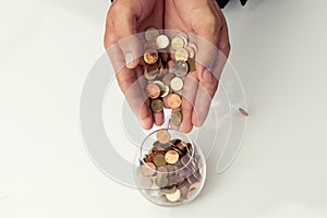 Businessman hand putting the coins on the glass, concept of saving  money for finance accounting