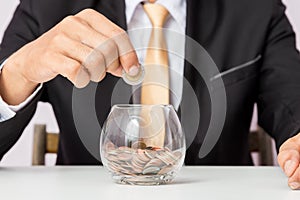 Businessman hand putting the coins on the glass, concept of saving  money for finance accounting