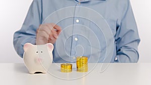 Businessman hand putting money in piggy bank and investment concept. Time lapse