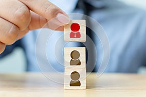 Businessman hand putting wood cube block on top with icon