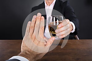 Businessman Hand Rejecting A Glass Of Whiskey