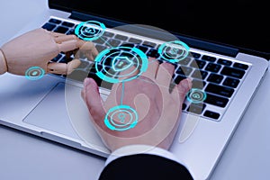 Businessman hand and robot hands show unity with two hands together is working labtop. Concept of Artificial intelligence,