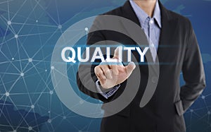 Businessman hand select wording quality.