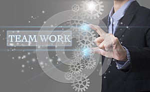 Businessman hand select wording Teamwork. sign on virtual screen.