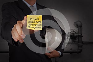 Businessman hand show project management words on sticky note wi