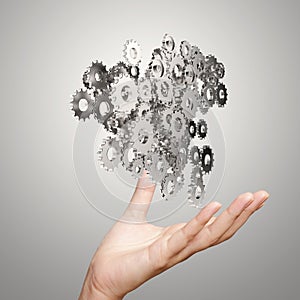 Businessman hand showing gears cogs to success
