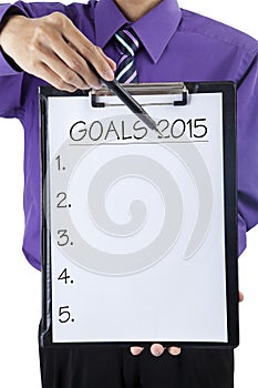 Businessman hand showing goals on 2015
