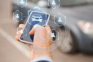 Businessman hand with smartphone car sharing app