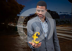 businessman with hand spread of with pounds fire icon over in the city at night