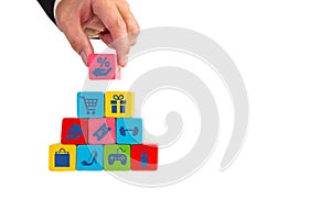 Businessman hand take wooden cube with shopping sales icon